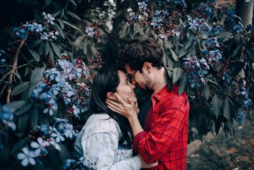 Man and Woman Hugging in the Middle of Flowers