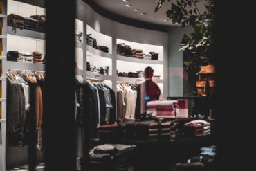 Man in a closet full of tailored suits